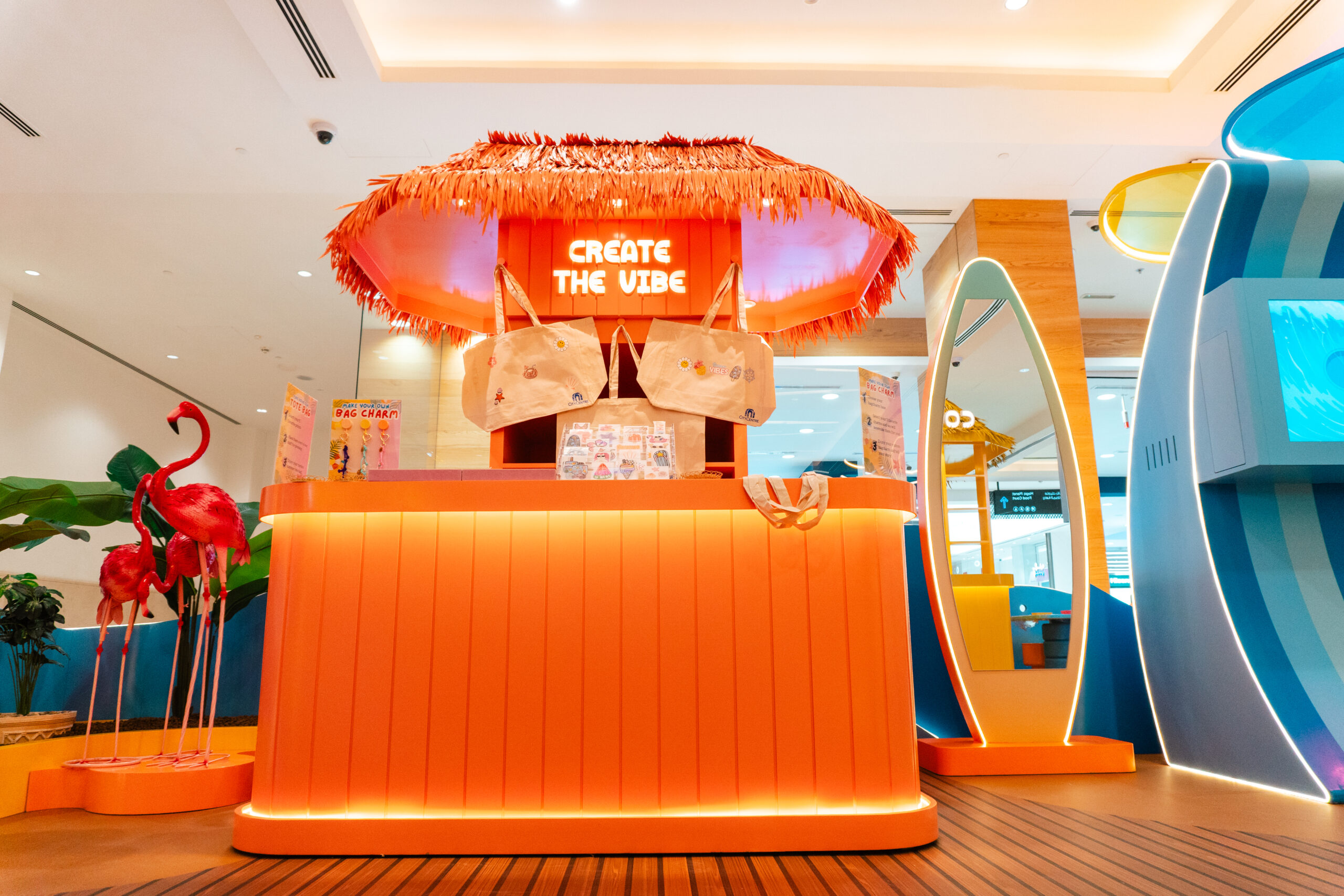 The Create the Vibe counter in orange and coral, staffed and stocked for the activation