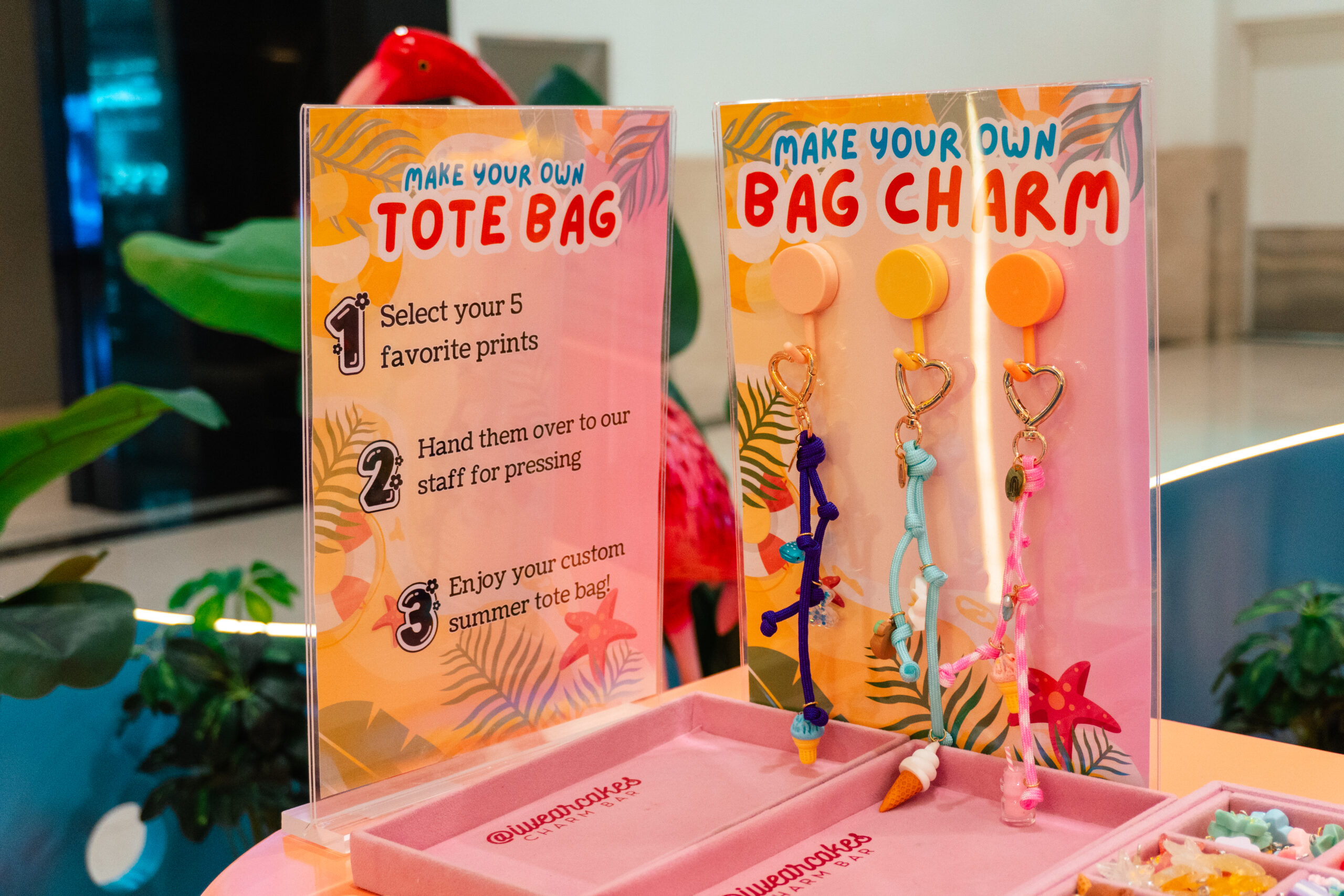 Instruction cards for the Make Your Own Tote Bag and Bag Charm activities, with finished charms alongside