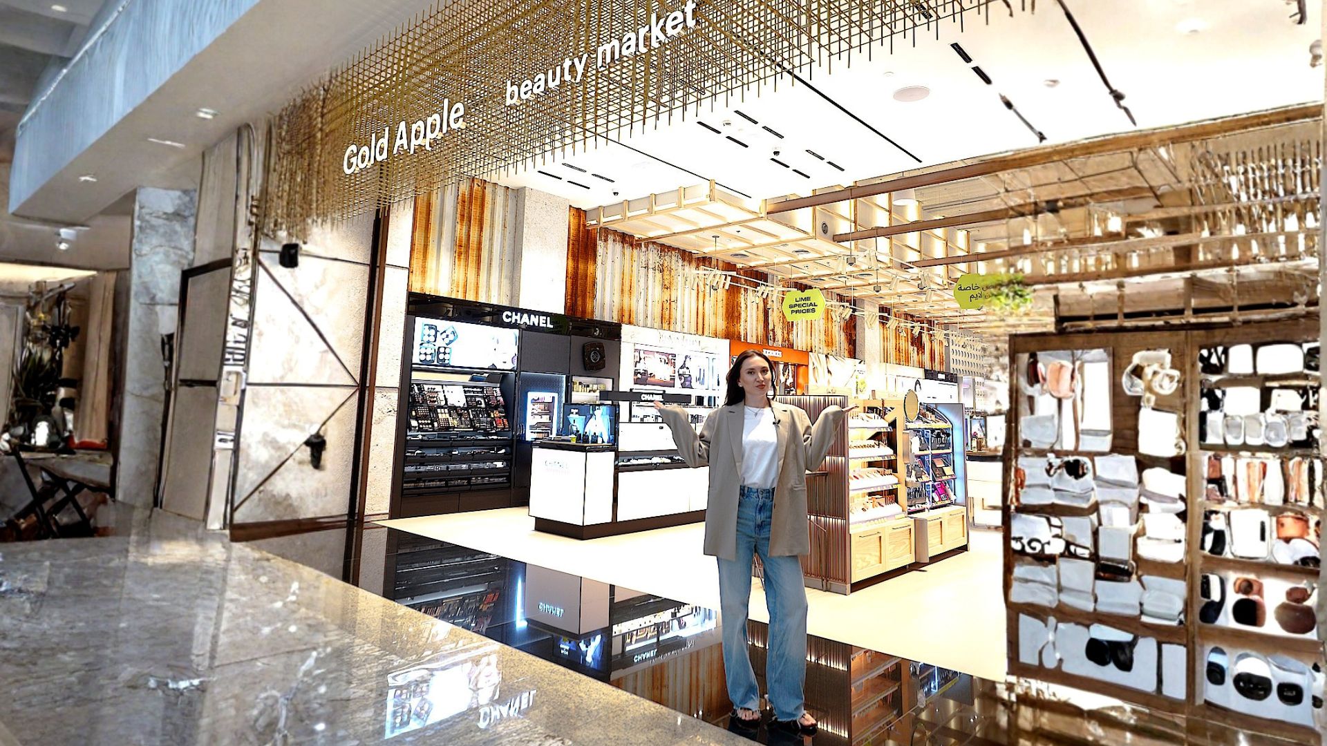 The Gold Apple beauty market storefront, with a presenter standing under the entrance sign.
