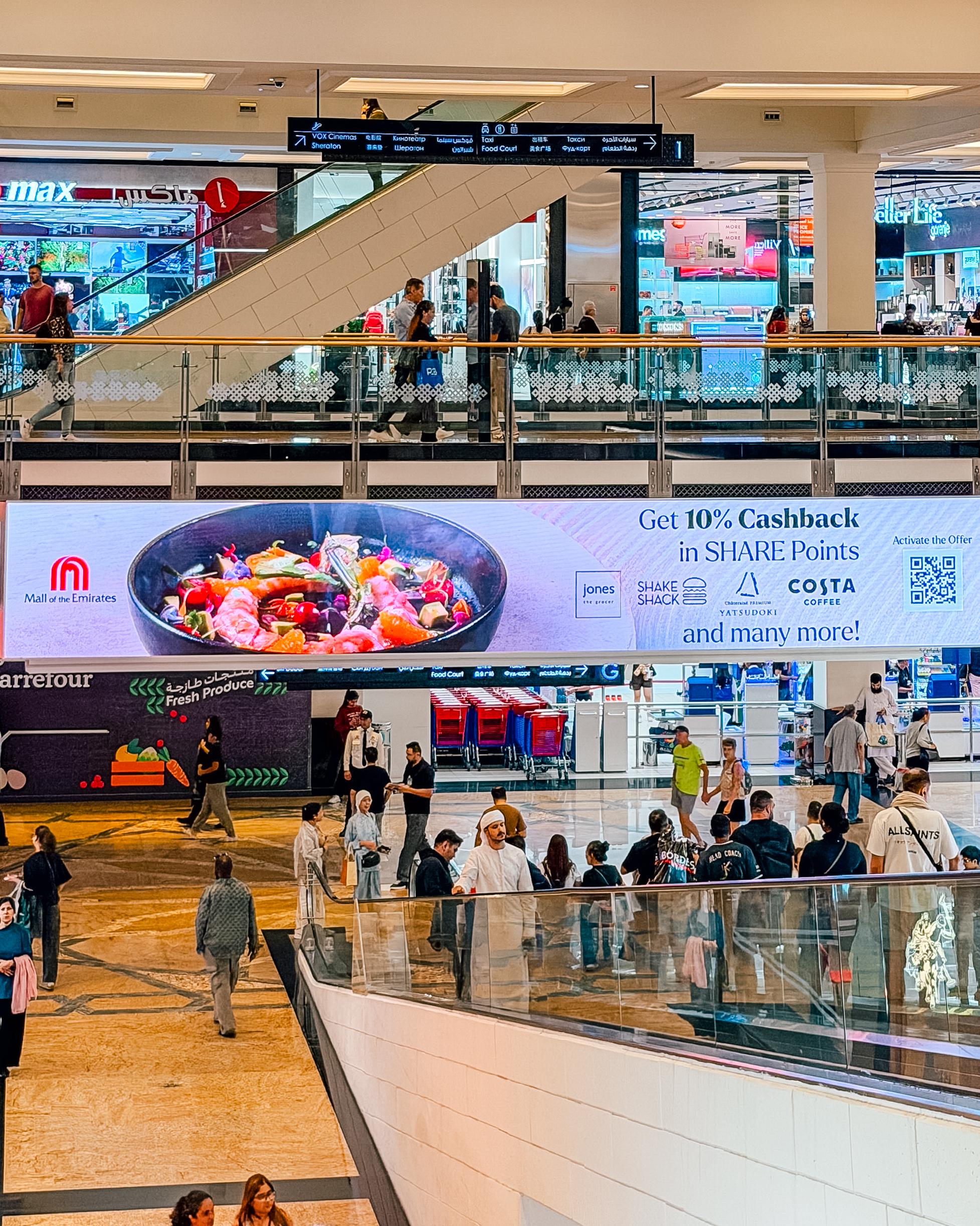 A SHARE Points 10% cashback billboard above the Carrefour entrance at Mall of the Emirates.