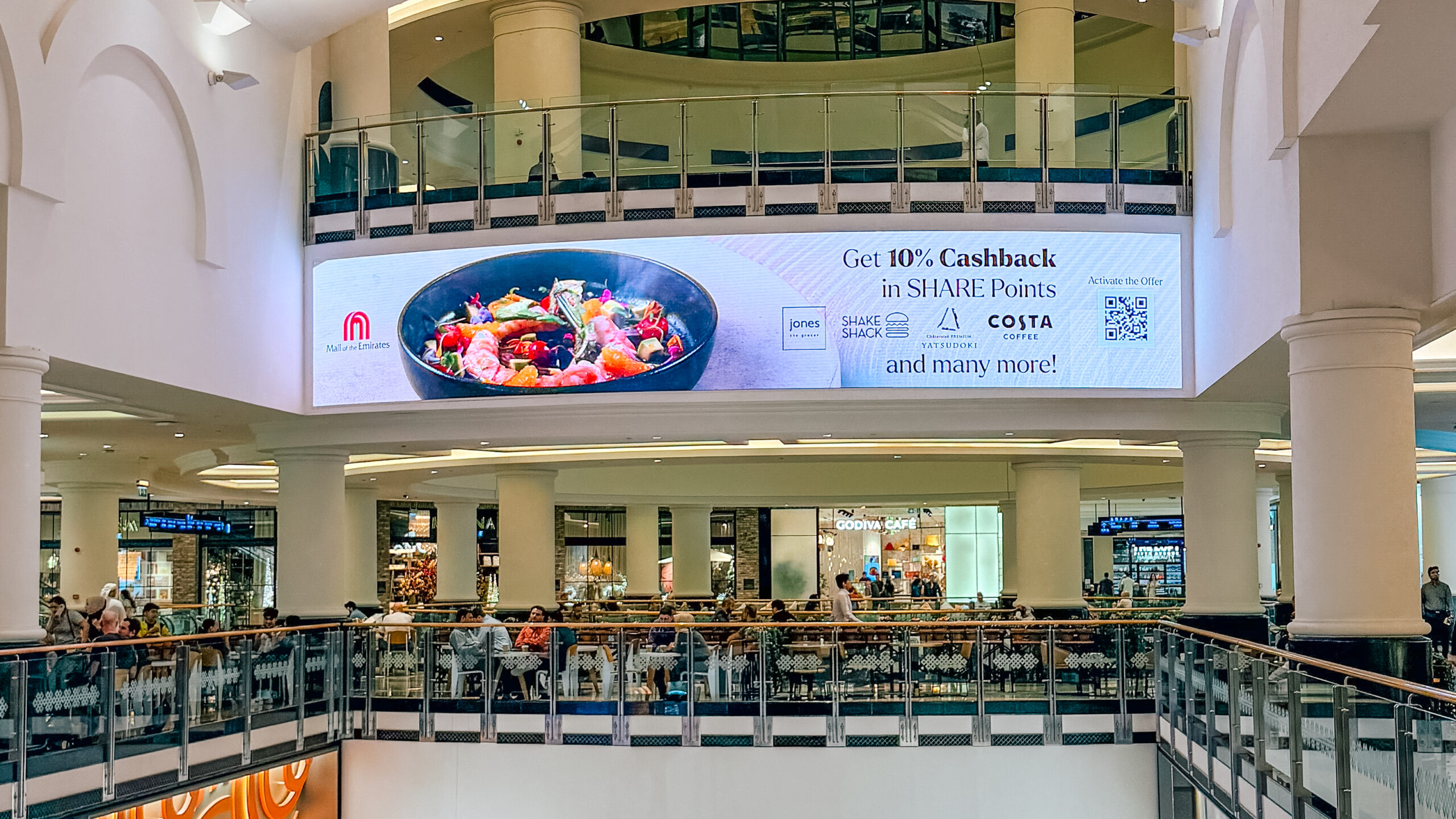 The SHARE Points cashback billboard above the dining balcony at Mall of the Emirates.