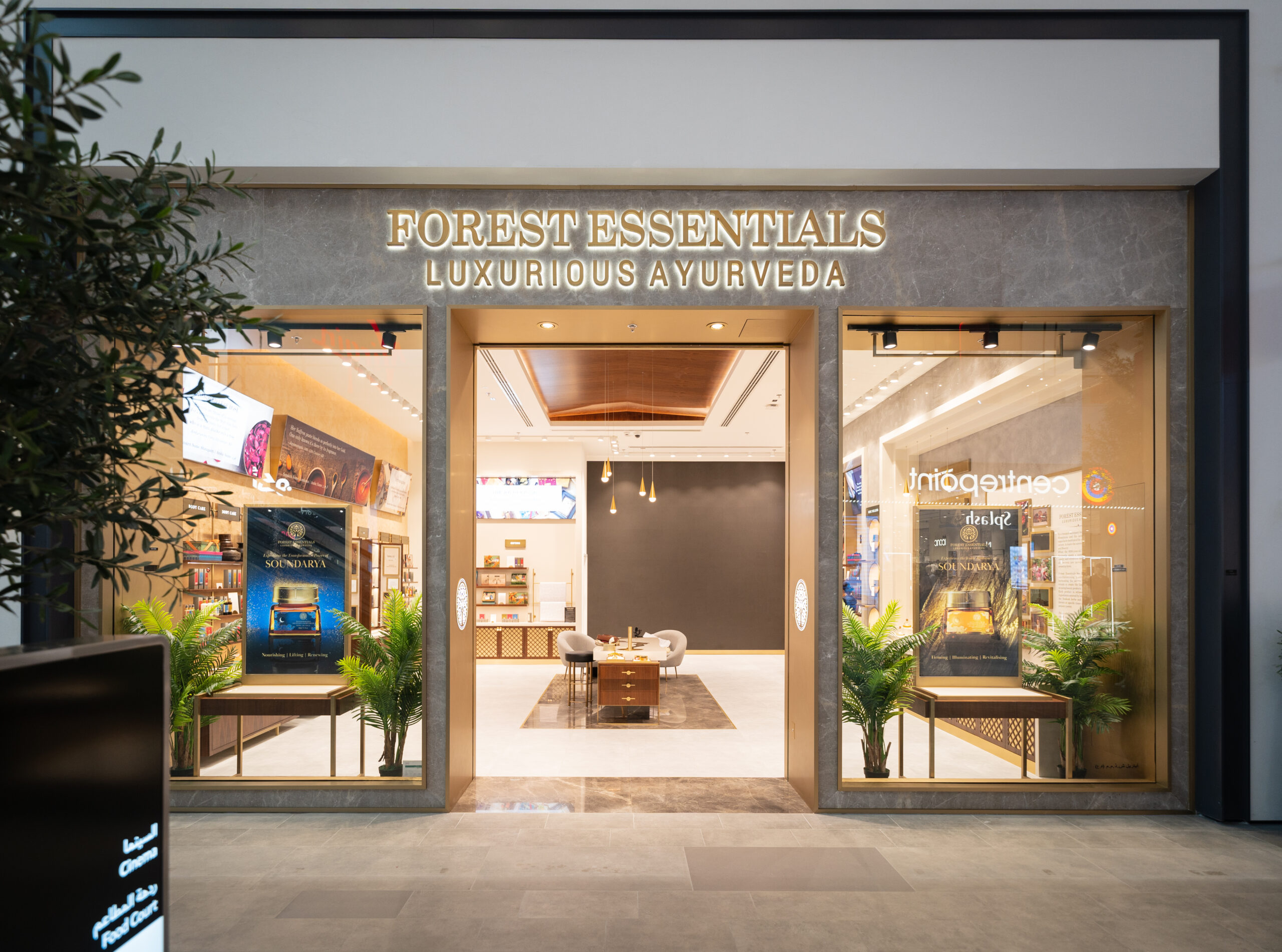 The Forest Essentials storefront at Dubai Hills Mall, gold Luxurious Ayurveda lettering lit above the open entrance